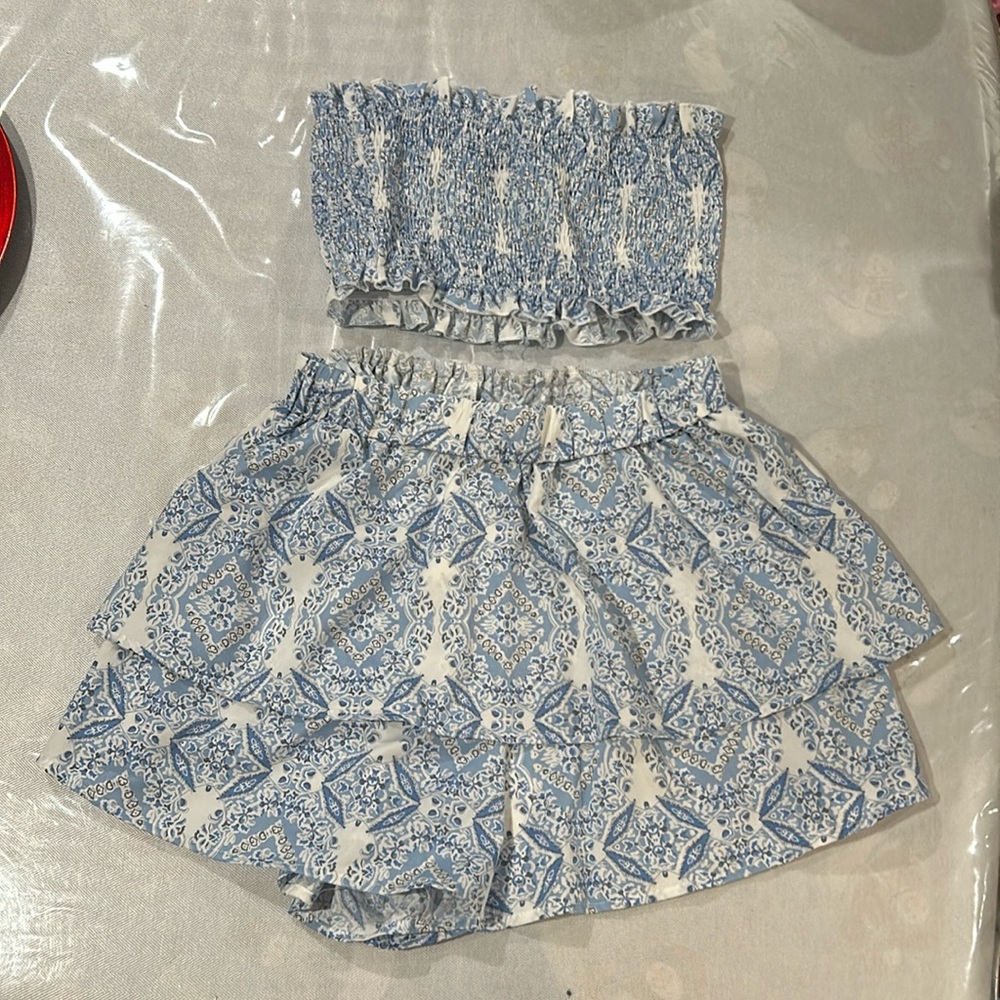 Two piece, strapless top and skort.